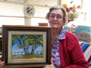 Bernice Carter with her painting "Snow Scene at Wongala Barraba 1"